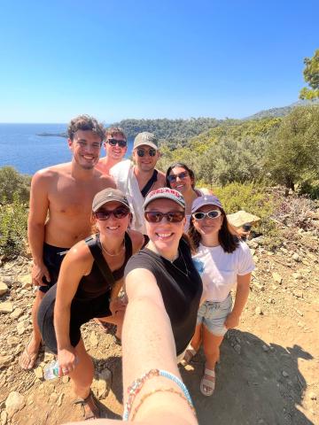 A wide-angle selfie of a group of people smiling in Turkey