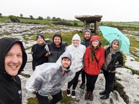 A group of people wearing raincoats on the Cliffs of Moher