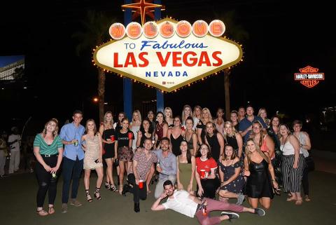 Topdeckers in front of a Las Vegas sign