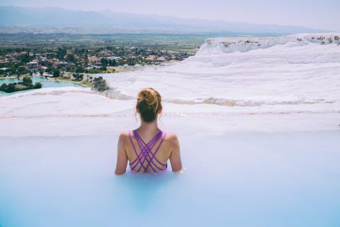 woman emerged in a hot spring with her back to the camera