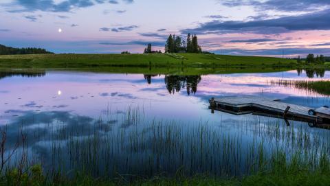A purple and blue sunset on the river in Kolari, Finland.