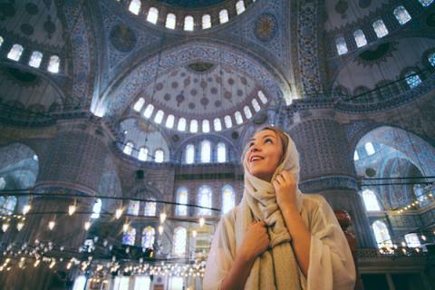 woman standing inside a beautiful Turkish building