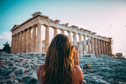 A woman looking at temple remains in Acropolis