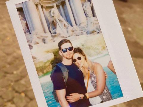 picture of a photograph of a man and woman couple embracing in front of the Trevi Fountain