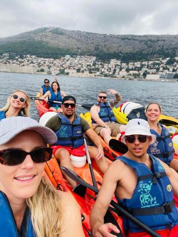 People sitting in canoe boats next to each other