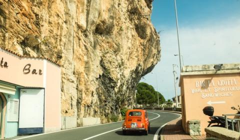 A car driving on a road on a cliff