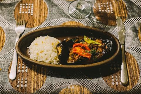 a plate of Karniyarik (Stuffed Eggplant) with rice
