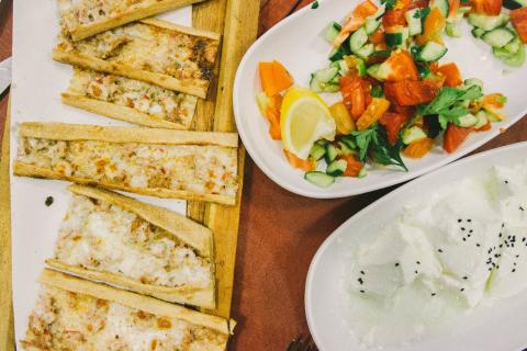 A plate of Etli Ekmek (Turkish Pizza) and a side salad
