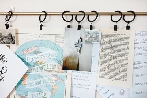 a mood board hanging on rings