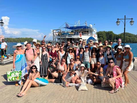 Topdeckers posing in front of a boat
