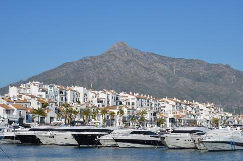 Boats and houses in front of mountains in Costa del Sol