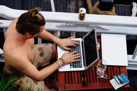 A person typing on a MacBook computer
