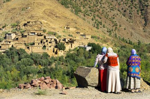 Three people standing by mountains in Morocco