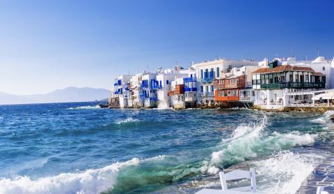 White, blue and orange houses by the sea in Greece