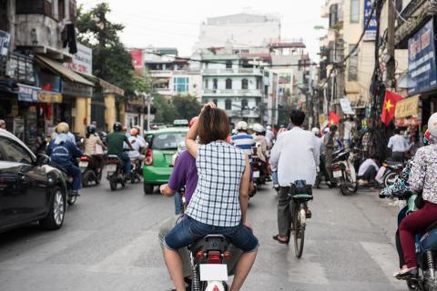 Cars and cyclists on a road in Vietnam