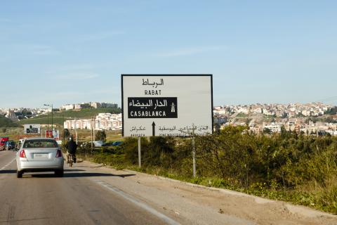 A road sign and a car on a road in Morocco