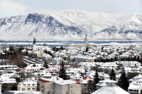 Snowy buildings and a mountain in an icelandic town
