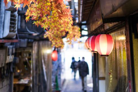 lanterns hanging outside a restaurant in an alleyway