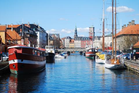 A canal with boats on it and houses surrounding it
