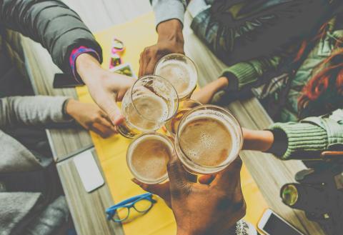 A group of friends holding up beers in Berlin