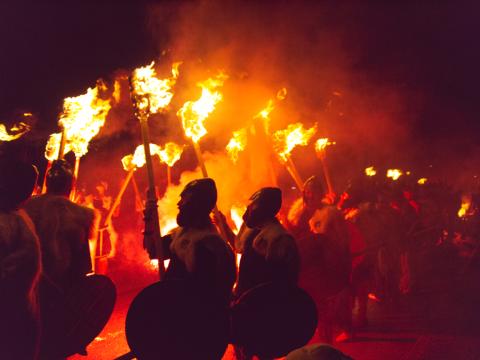 Viking look-alikes carrying flaming torches