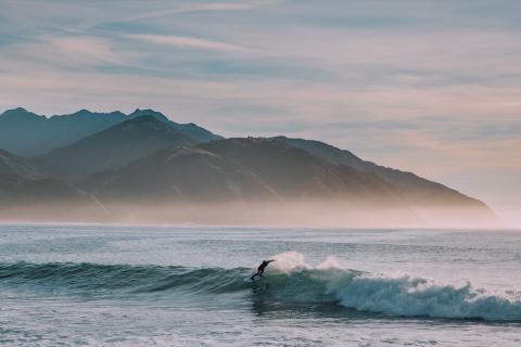 A person surfing a huge wave in kaikoura, new zealand
