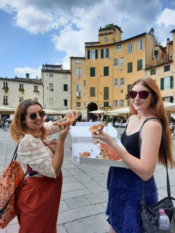 Two women eating pizza 