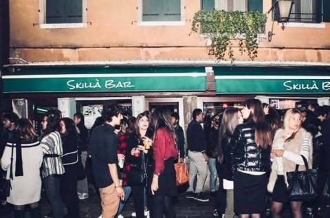 crowd of people in front of a bar 