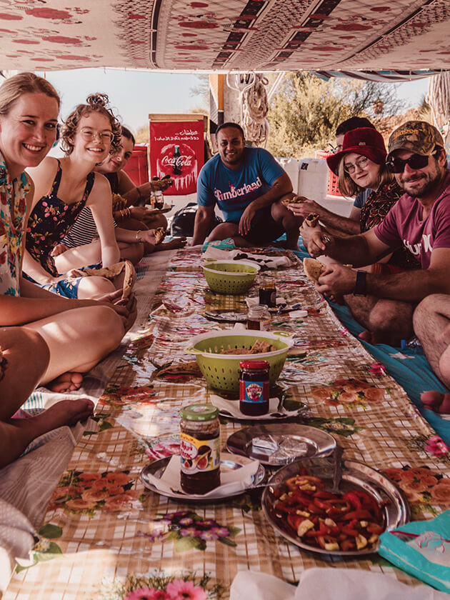 Topdeck travel group enjoying a meal with each other.