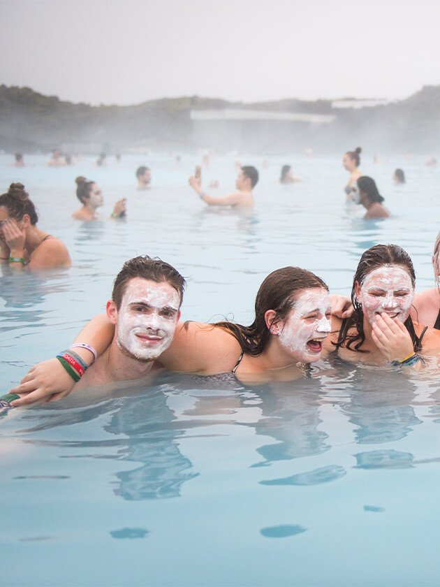 Topdeck travelers enjoying the waters of the Blue Lagoon.