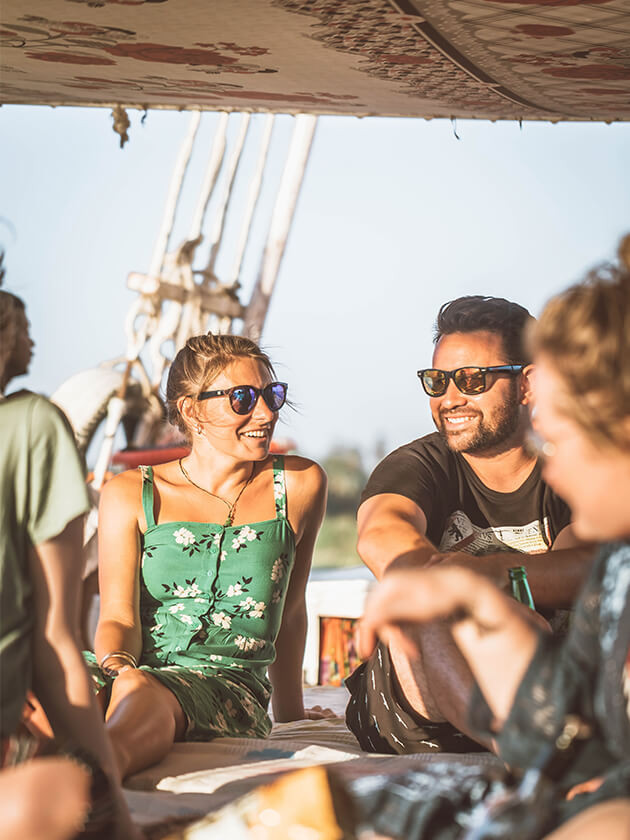 Topdeck travelers taking a sailing tour down the Nile River. 