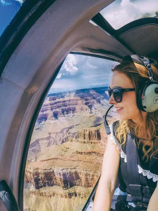 Topdeck traveler taking a helicopter tour of the Grand Canyon.