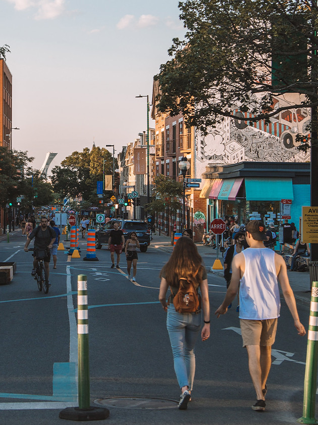 Topdeck travelers walking down street in Montreal Canada.