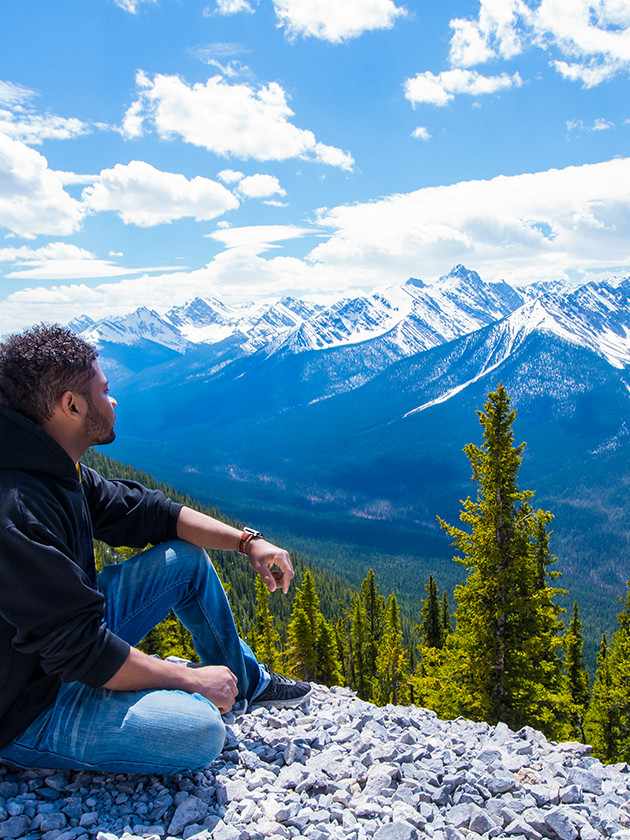 Topdeck Traveler looking out towards a view of the Rocky Mountains.