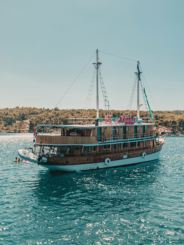 A boat sailing the Croatian coastline of the Adriatic Sea.