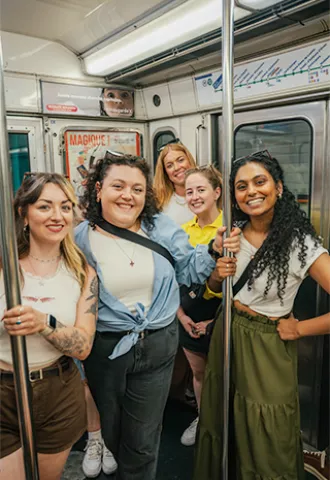 People smiling together on the underground metro in Paris.