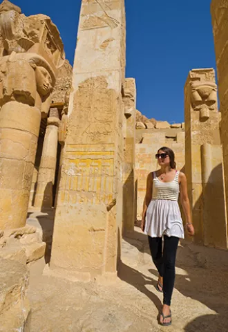 Person walking through the walls of a Middle Eastern temple.