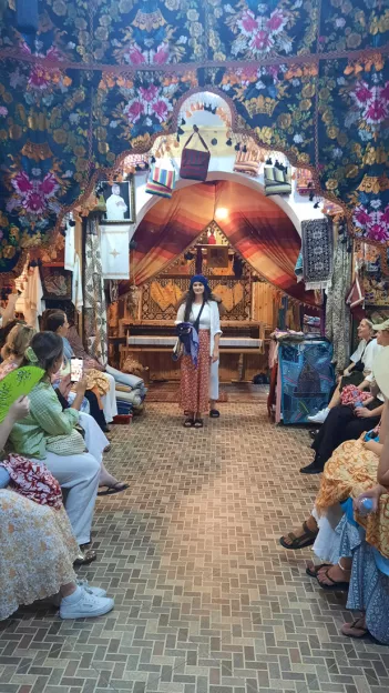 People sitting inside a Moroccan textiles souk.