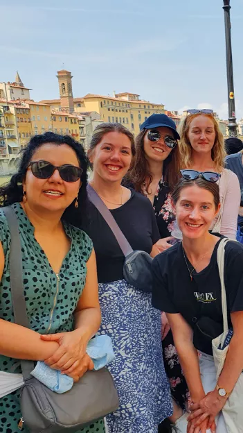 Group of people smiling together in a European city.