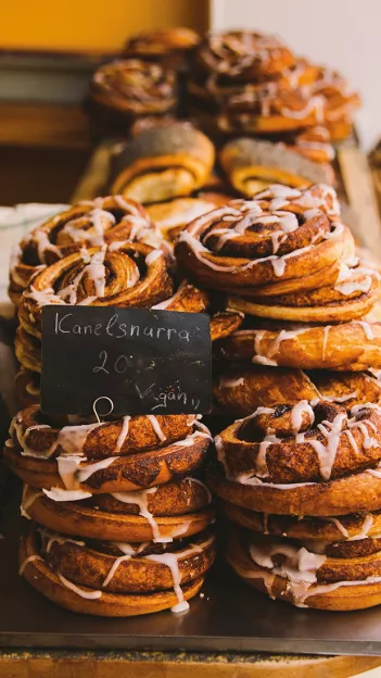 Multiple stacks of baked goods covered in a white icing.