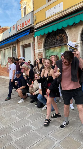 Topdeck travelers posing for a photo with their ice cream on the streets of Venice.
