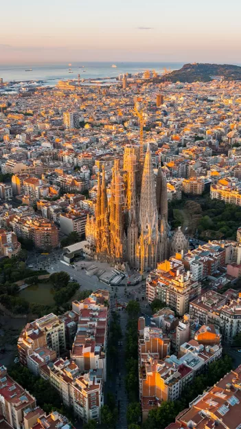 View of Sagrada Familia in between Barcalona city street blocks.