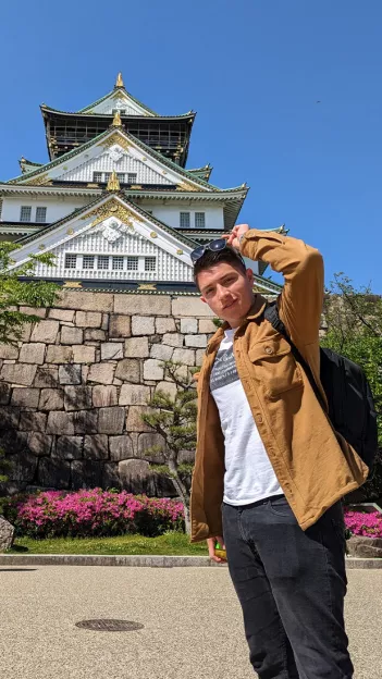 Person standing in front of Osaka Castle in Japan.