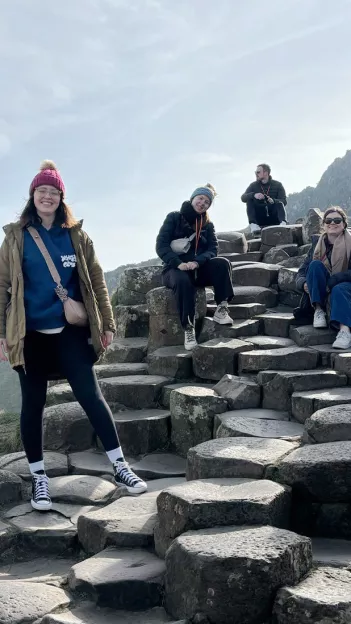 People posing together for a photo on the Giant’s Causeway in Northern Ireland.