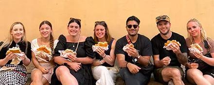 A Topdeck Tour group posing with their doner kebabs during lunch.