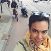 Smiling woman with sunglasses on her head taking a selfie