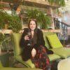 Woman sitting on a green chair