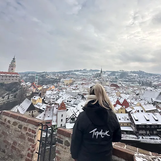 A woman with a Topdeck hoodie looking out over the medieval city of Ljubliana.