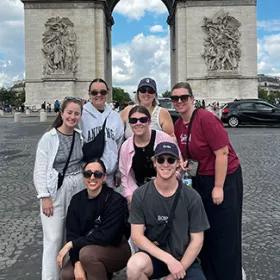 Topdeck Travellers posing in front of the Arc de Triomphe in Paris.