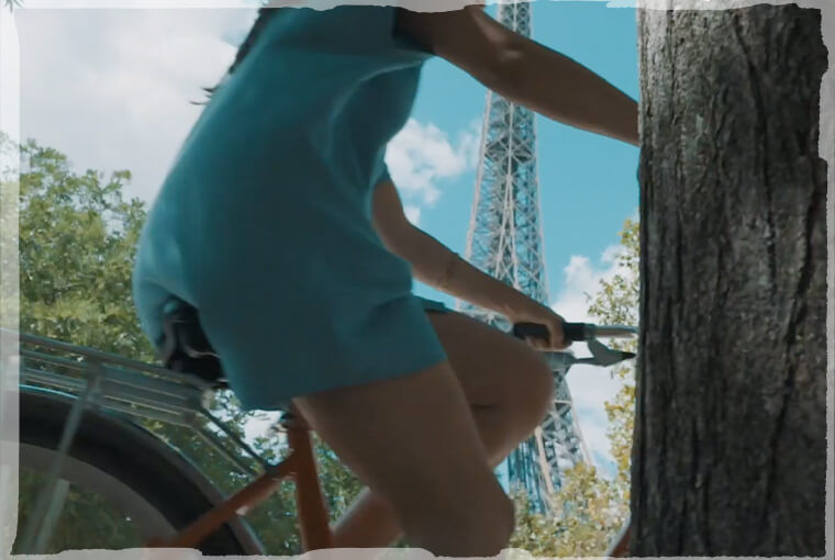 Topdeck Traveler cycling by Eiffel Tower in Paris.